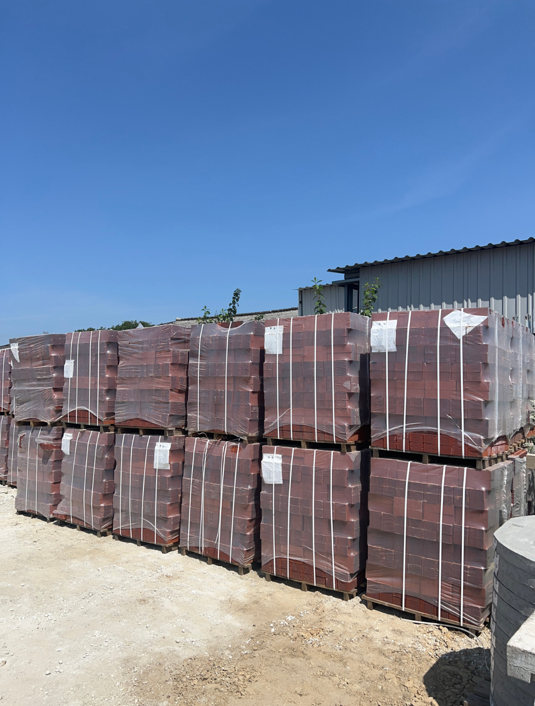 Projects - Birstall Several packs of bricks on site with a blue sky in the background