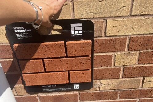 Brick Match - Forterra Harthill Red Image is a sample panel of red bricks held against a wall